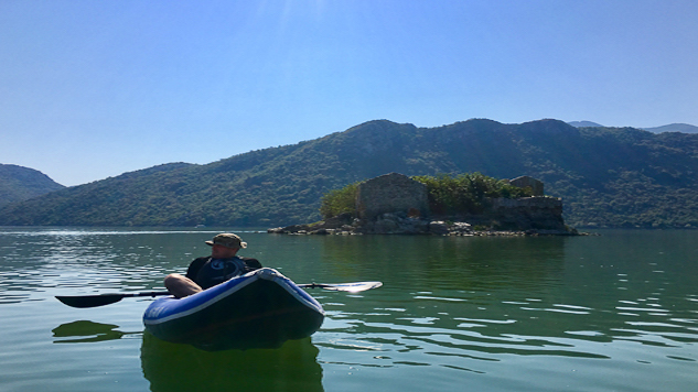 Kayaker in front of Grmozur island prison on Lake Skadar.jpg